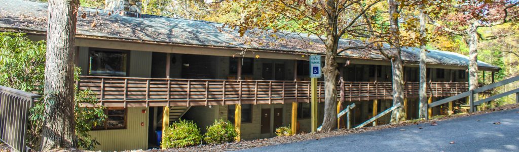 Kohnjoy Inn at Lutheridge, a two-story lodge with a long wooden balcony among fall trees