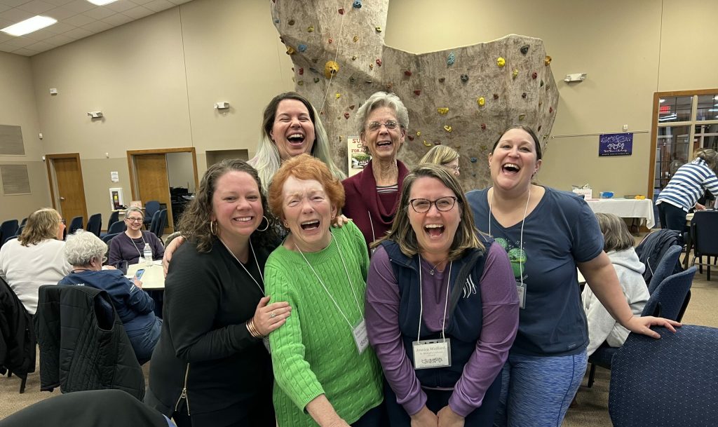 Women laughing together in a group photo at Wild Women Weekend at Lutheridge
