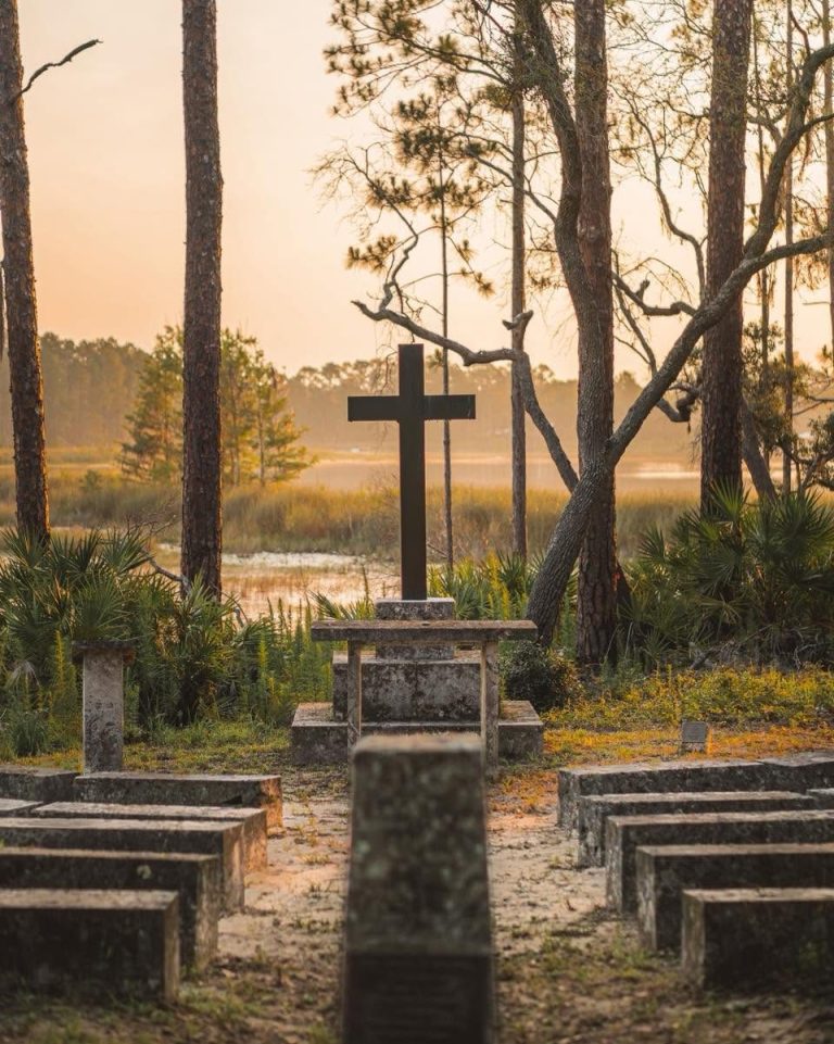 The outdoor chapel's cross and stone benches at Luther Springs at sunrise