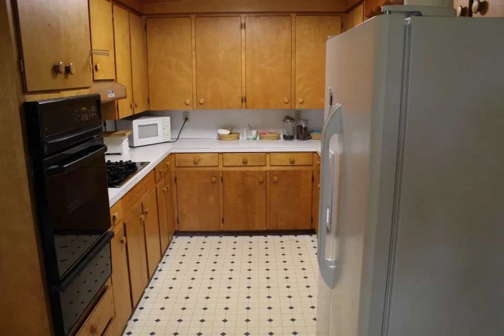 The Bacot Center kitchen: wall oven, cooktop and a full-size refrigerator