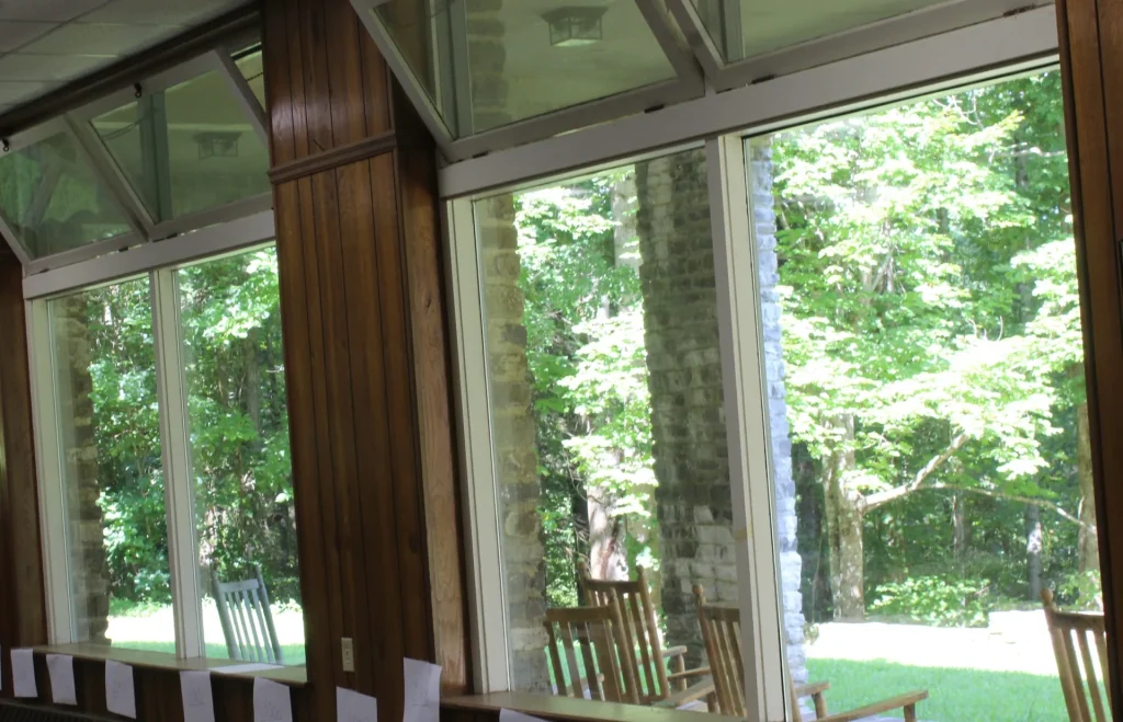 Tall windows in Efird Hall looking out into the trees