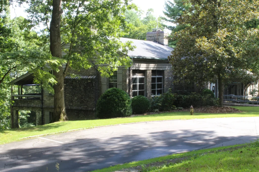Efird Hall from the drive, under tall trees