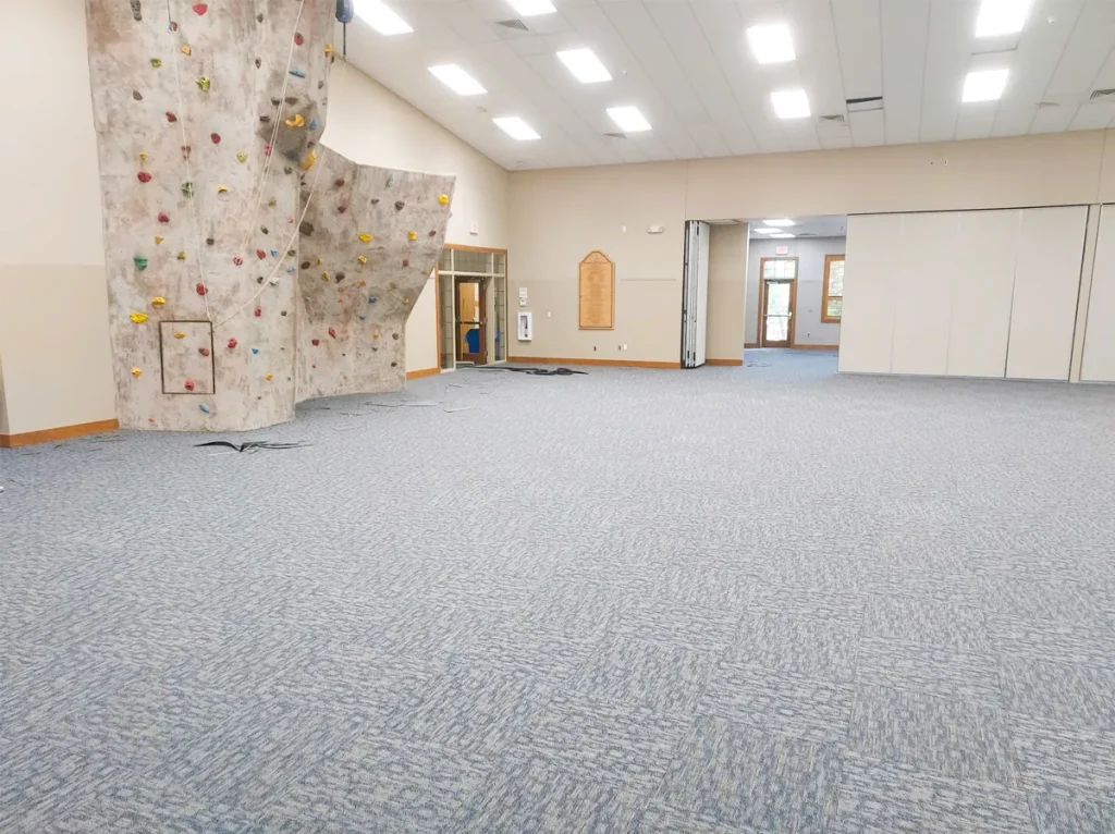 The climbing wall at one end of the Faith Center hall