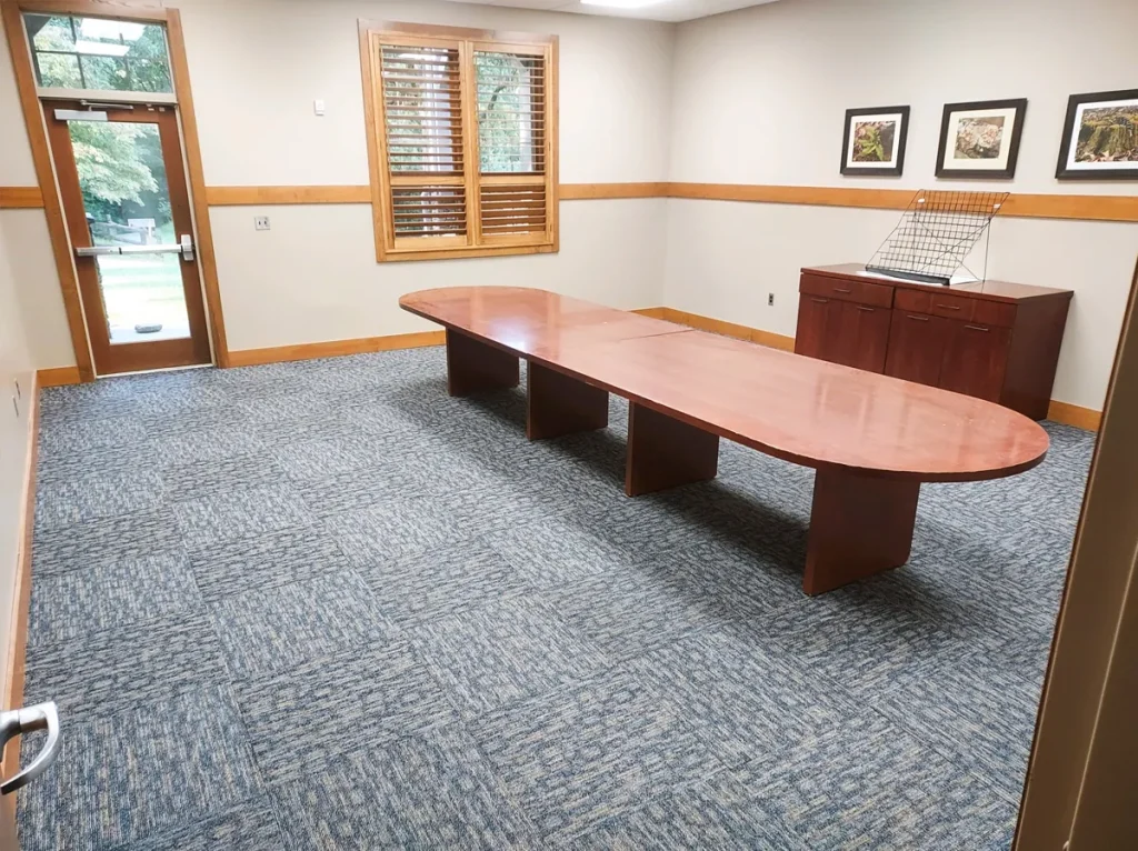 A second Faith Center conference room with a long wooden table