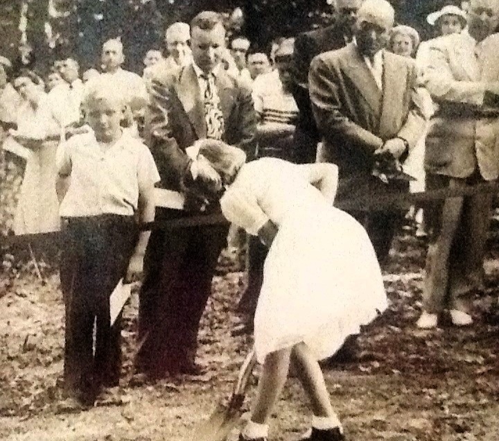 Shirley Katzenmoyer Maney, age 8, turns a shovel of dirt at the 1950 groundbreaking for Lutheridge