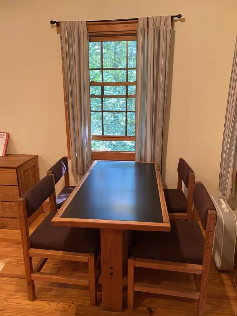 A table for four by the window in a Lakeside Village cabin