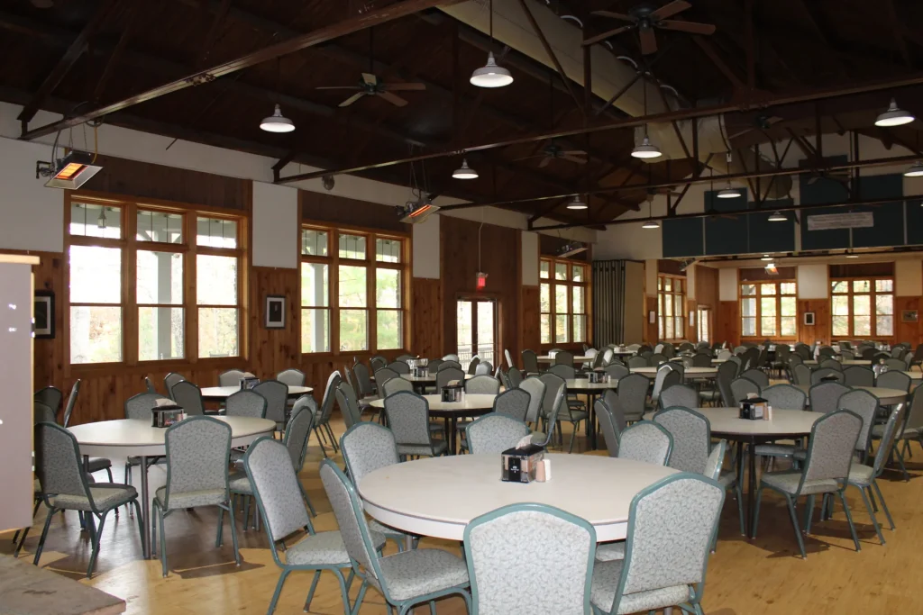 Lineberger's dining hall: round tables under an open timber ceiling