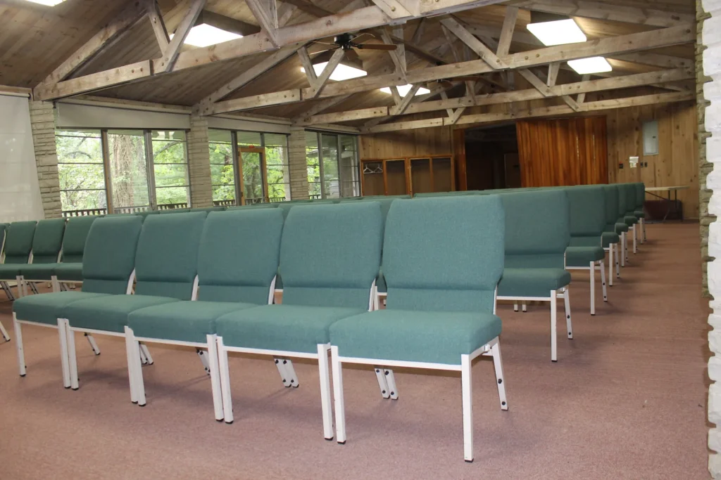 Rows of upholstered chairs in Mission Hall