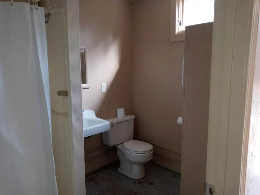 A Wilderness Cabin bathroom with a shower, sink and toilet