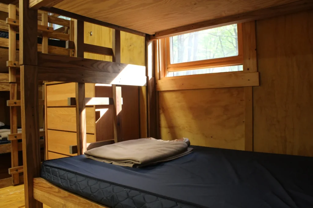 A bunk bed under the window in a Cabin Village cabin
