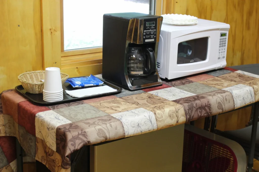 A coffee maker and microwave in a Cabin Village cabin