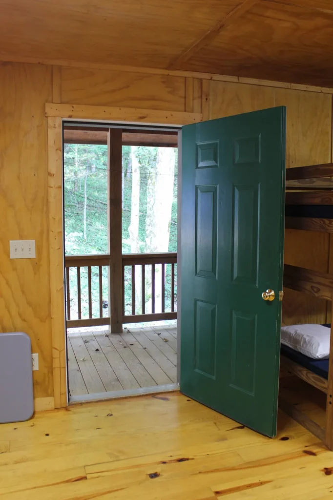 A Cabin Village cabin door opening onto the porch