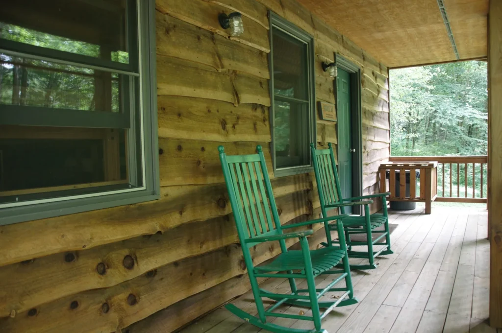 Green rocking chairs on a Cabin Village porch