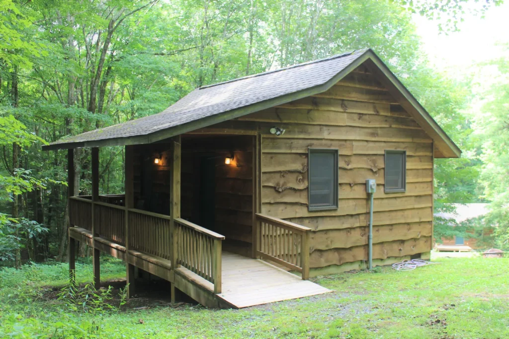A Cabin Village cabin with its ramp up to the porch