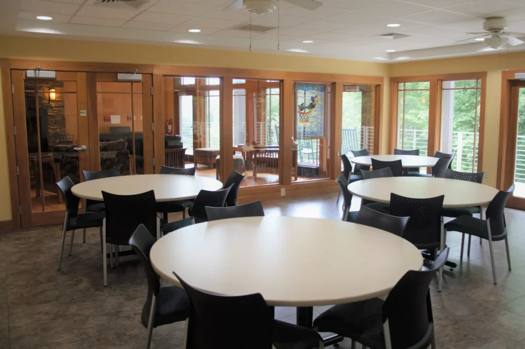 Round tables in a Crow's Nest room with windows on two sides