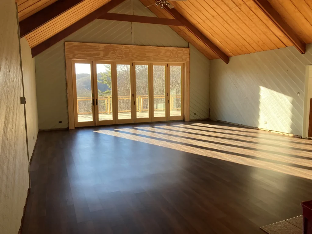 Founders Lodge's hall: a vaulted wood ceiling and glass doors to the deck