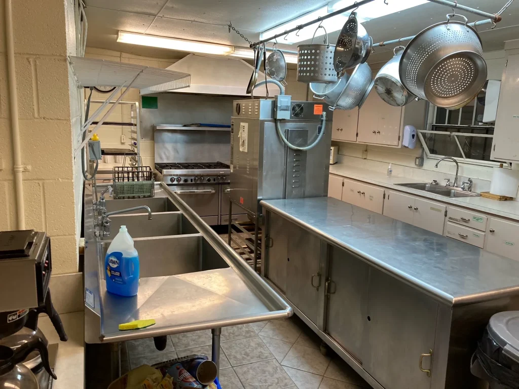 The Founders Lodge kitchen: stainless counters, sinks and a range