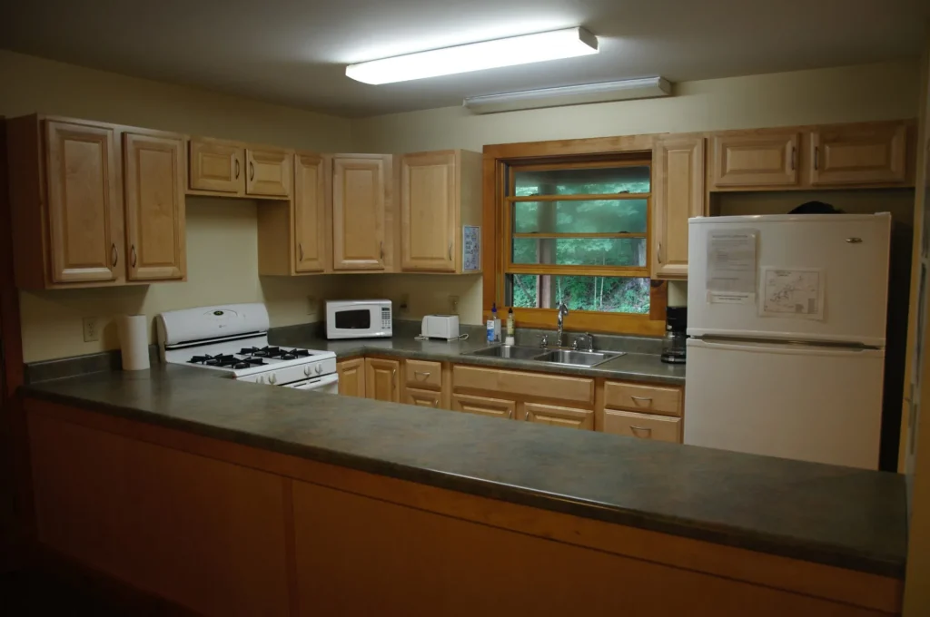 The Moretz Cabin kitchen with a range, refrigerator and long counter