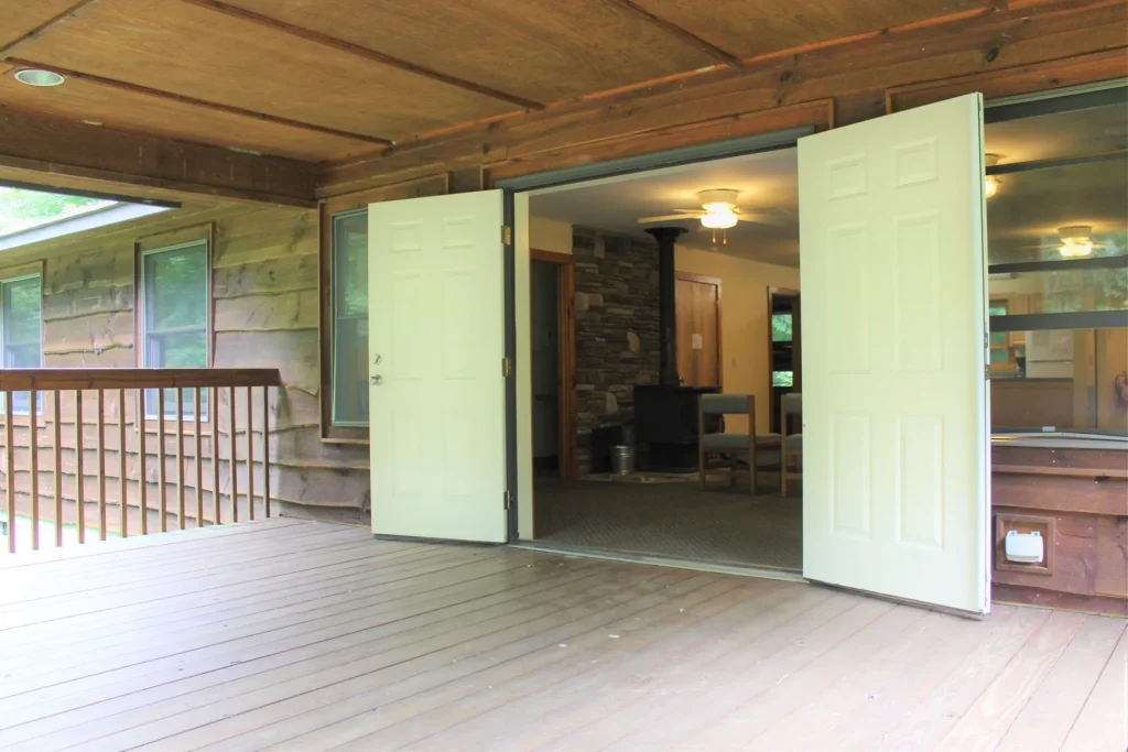 Moretz Cabin's porch with double doors open into the cabin