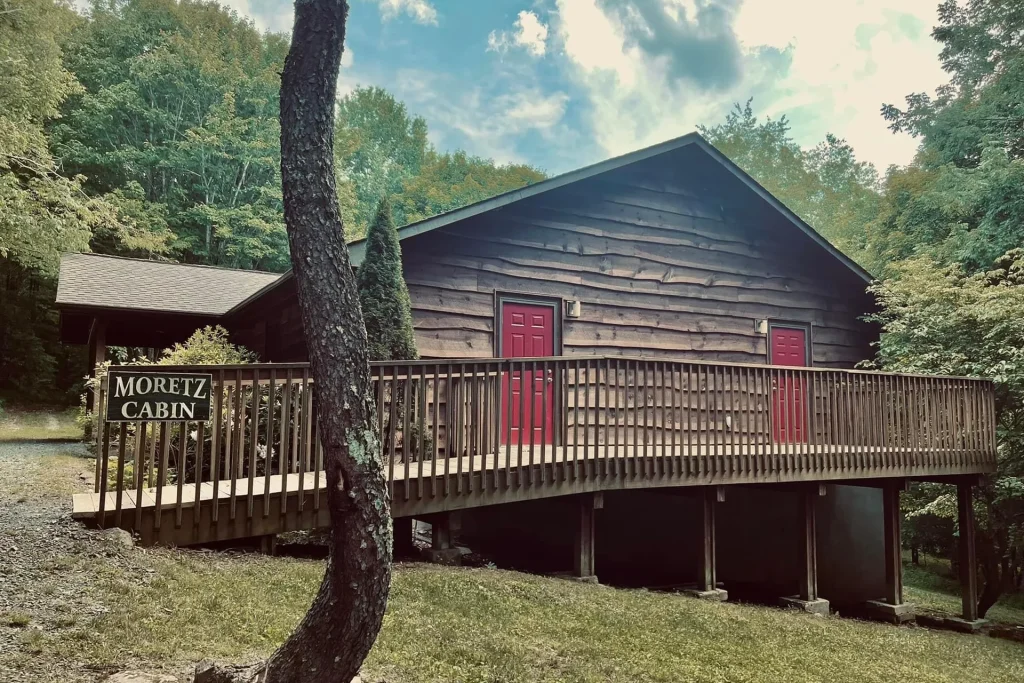 Moretz Cabin at Lutherock, with its sign on the long wooden deck