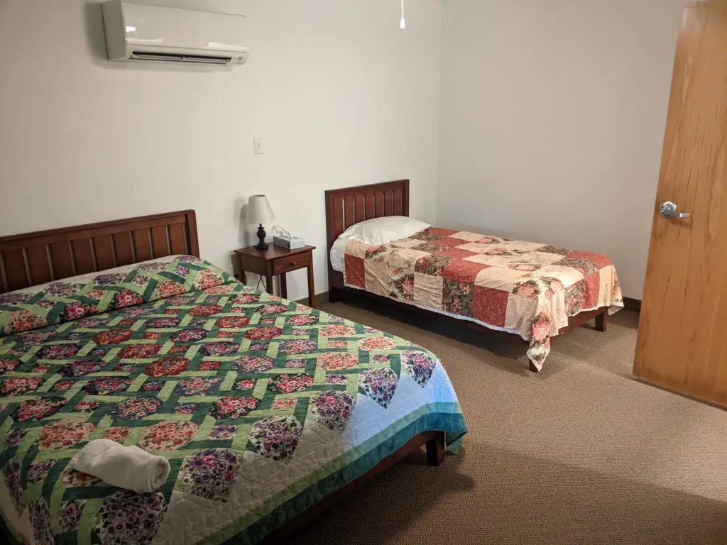A Kuehner bedroom with two beds and quilts