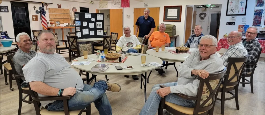 Members of the Master Builders group gathered around tables in a dining hall