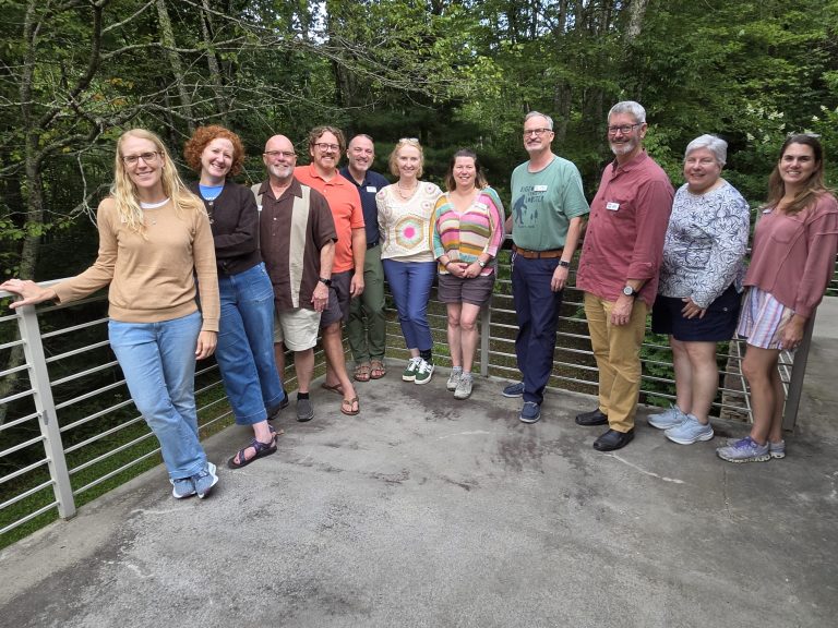 The NovusWay Board gathered on a deck at Lutherock, August 2026