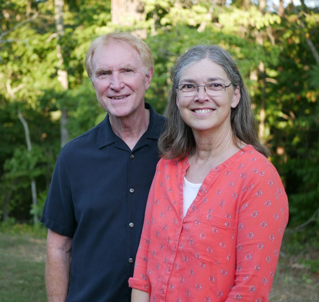 Pastors Tim and Mary Canniff-Kuhn smiling together outdoors